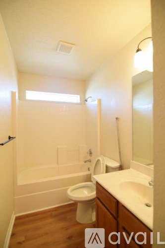 A bathroom with a toilet, sink and bathtub.