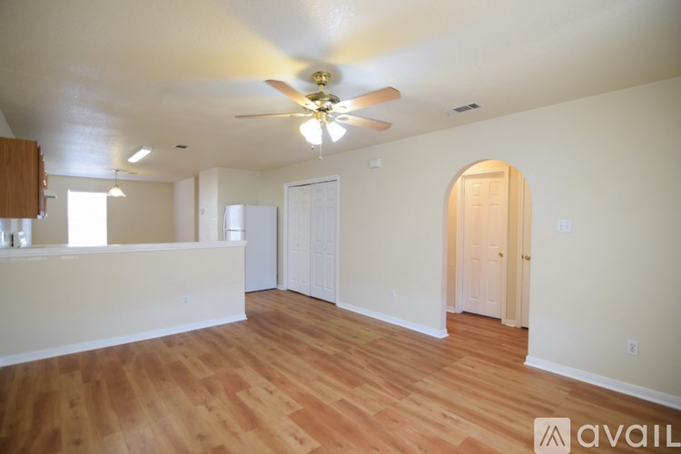 A room with wooden floors and a ceiling fan.