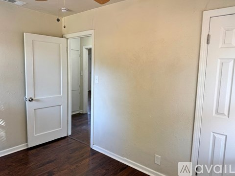 A room with a white door and a white wall.