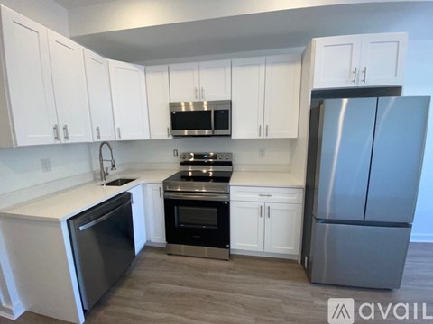 A kitchen with white cabinets and stainless steel appliances.