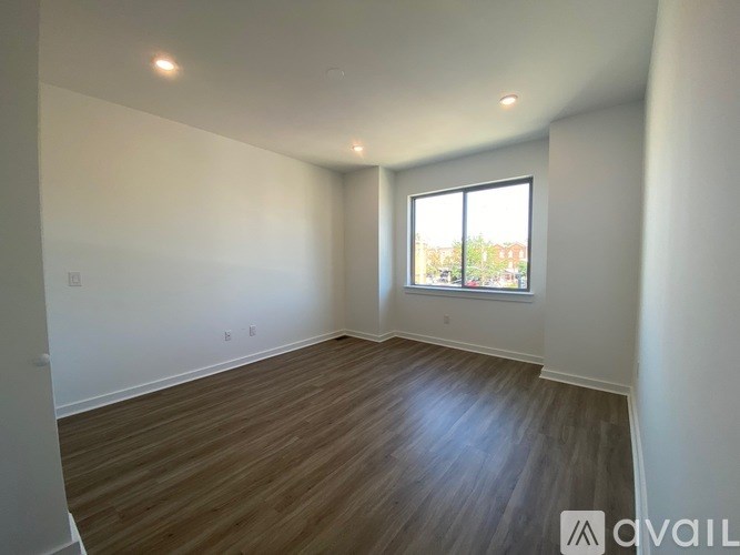 Empty room with wooden floor and a window.