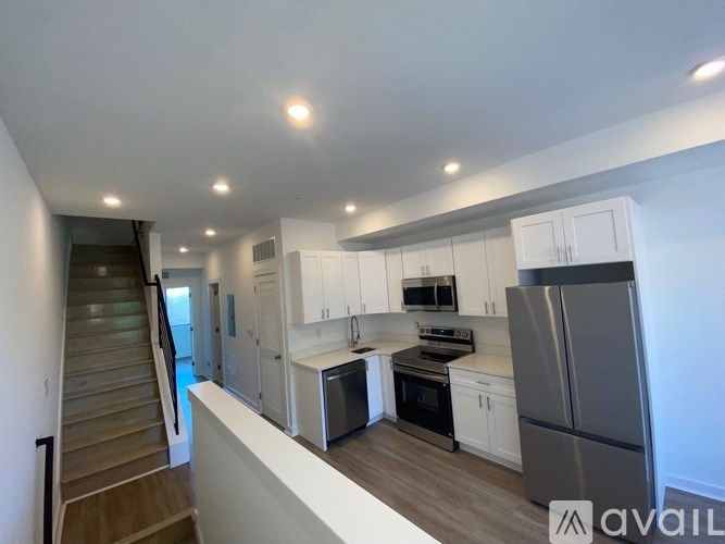 A kitchen with white cabinets and stainless steel appliances.