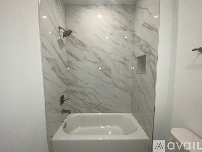 A white sink in a marble bathroom.