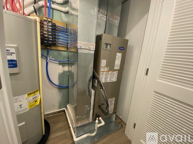 A room with a furnace and a wall of pipes.