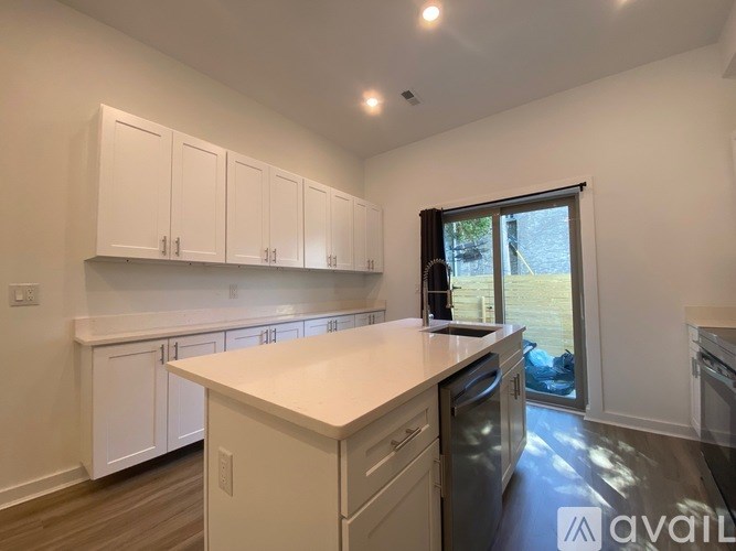 A kitchen with white cabinets and a countertop.