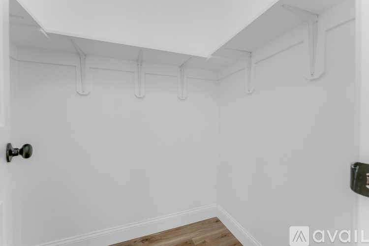 A white door with a black handle is on the left side of the image.