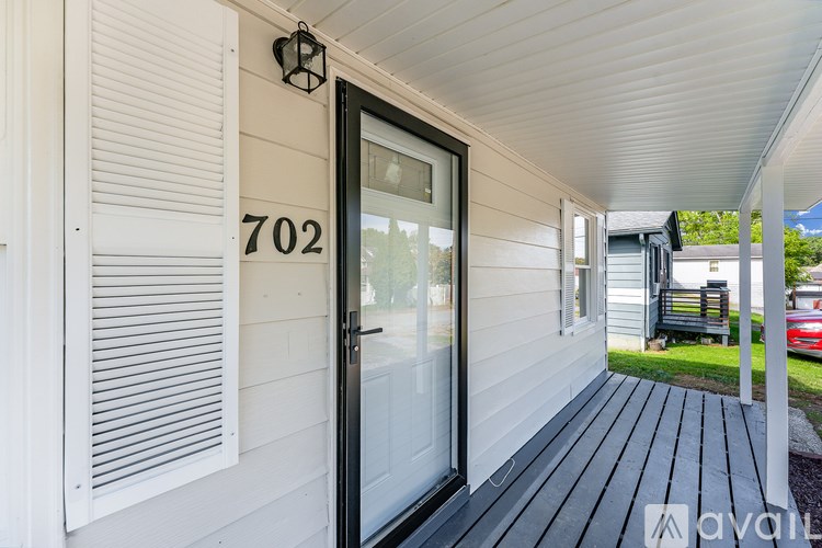 A white house with the number 702 on the wall.