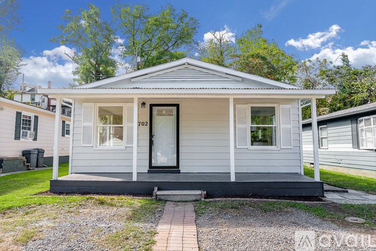 A small house with a porch and a front door.