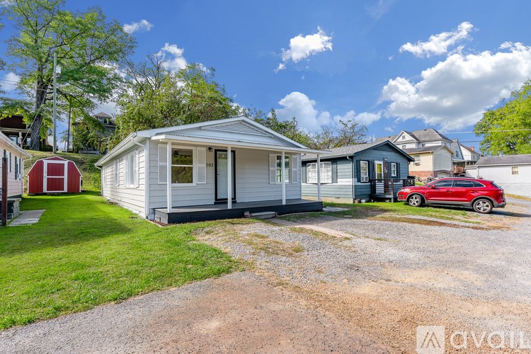 A house with a red car parked in front.