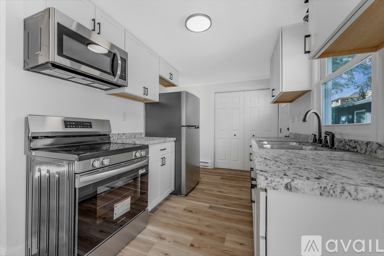 A modern kitchen with a stainless steel oven and microwave.