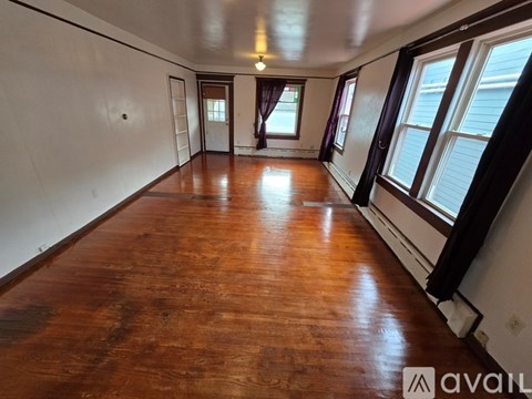 A room with wooden floors and white walls.