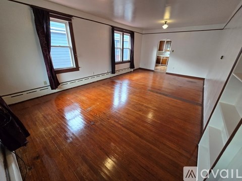 A room with wooden floors and white walls.