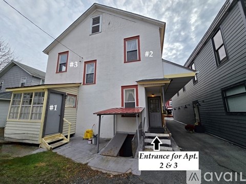 A house with the entrance for Apt. 2 & 3.