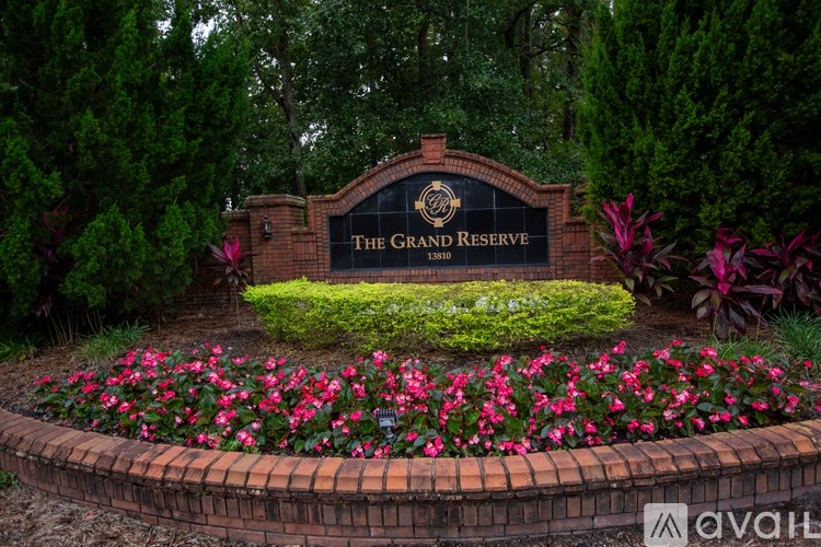 A sign that says "The Grand Reserve" is surrounded by flowers.