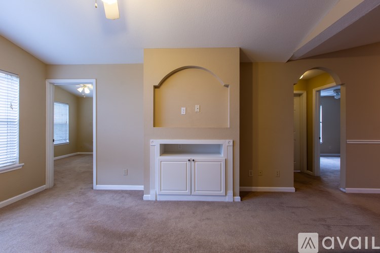 A living room with a fireplace and a carpeted floor.