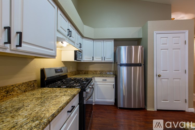 A kitchen with granite countertops and stainless steel appliances.