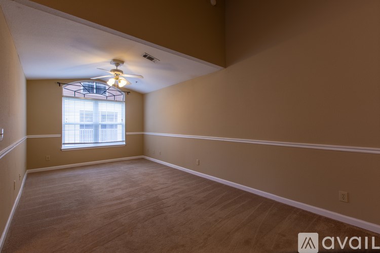A room with a window and a ceiling fan.