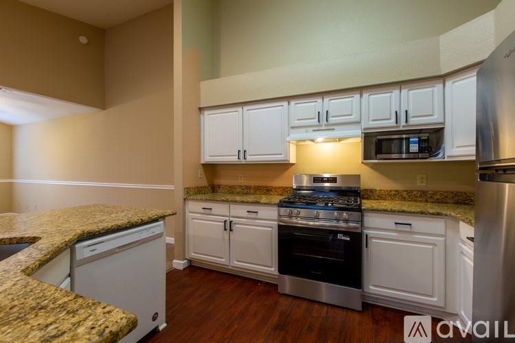 A kitchen with granite countertops and stainless steel appliances.