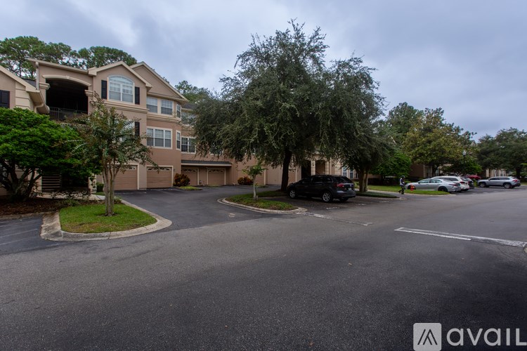 A residential area with houses and cars parked on the street.