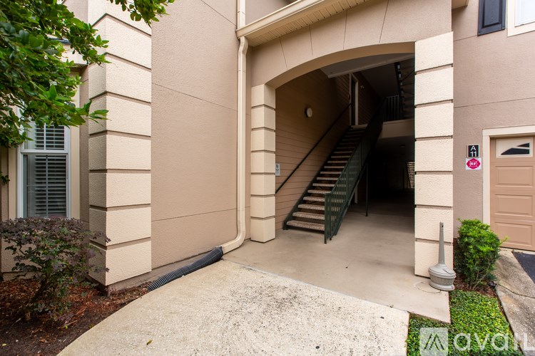 A building entrance with a staircase leading to the door.