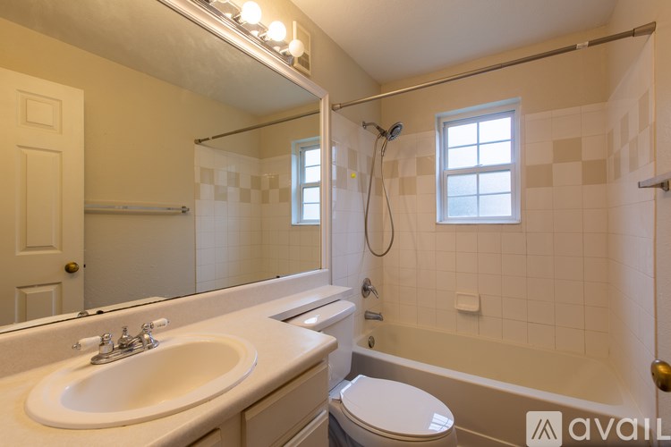 A bathroom with a sink, toilet, and bathtub.