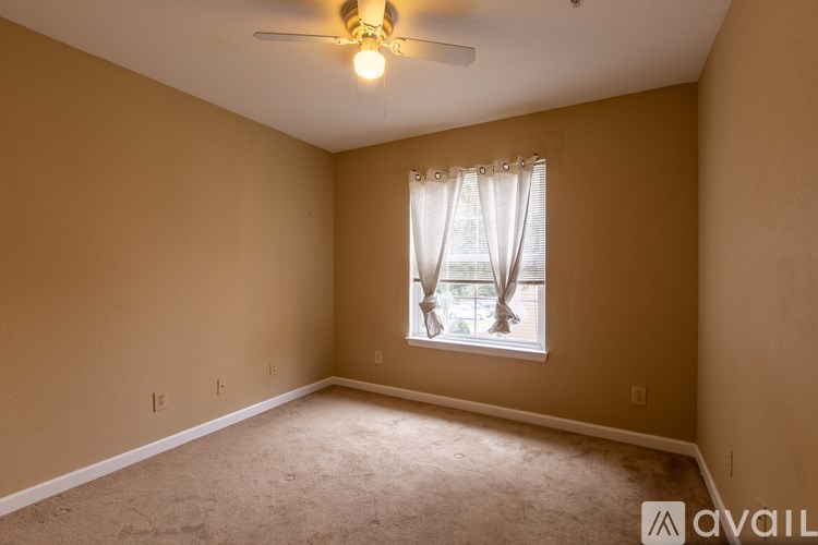 A room with a window and a ceiling fan.