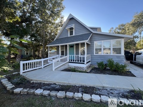 A house with a white fence and a small front yard.
