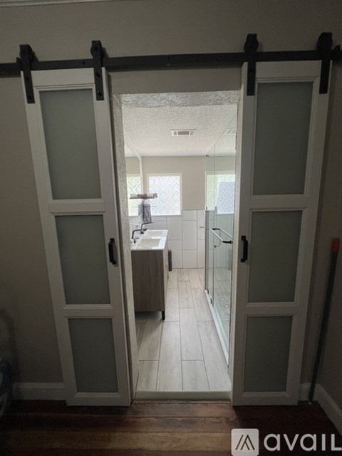 A white door with a glass window is open.