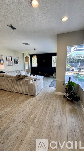 A living room with a couch and a television.