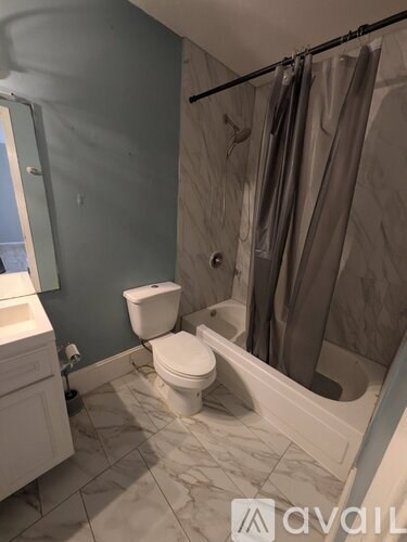 A bathroom with a toilet, sink, and bathtub.