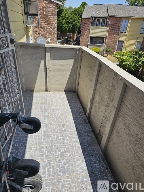 A balcony with a tire swing and a metal railing.
