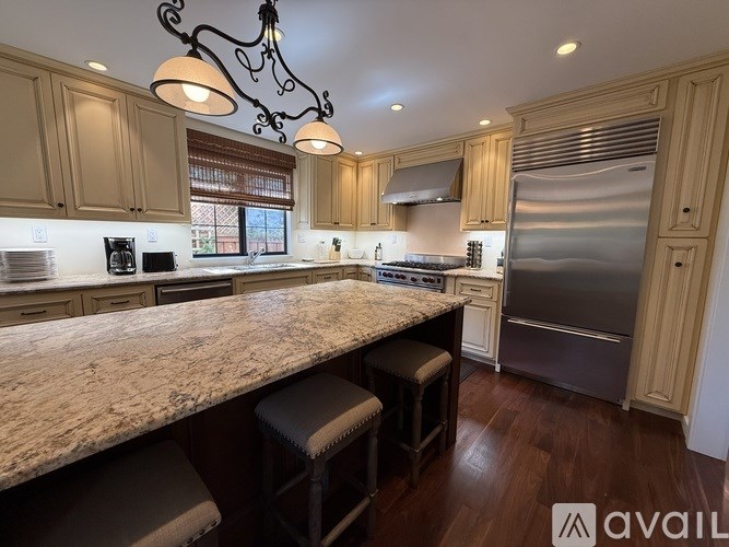 A kitchen with granite countertops and stainless steel appliances.