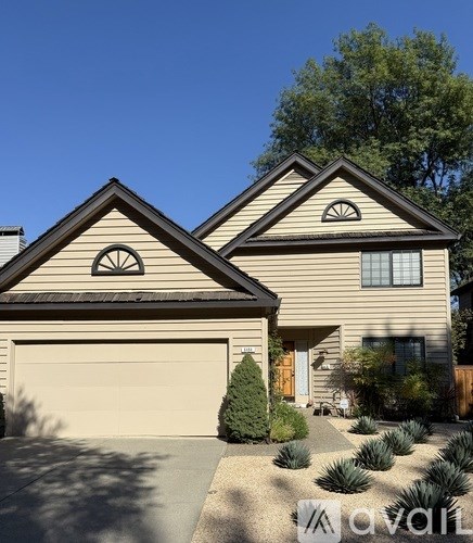 A house with a brown roof and a white garage door.