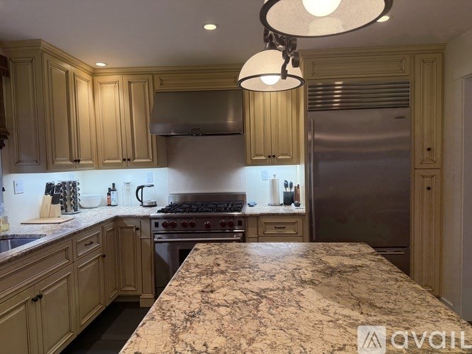 A kitchen with wooden cabinets and granite countertops.