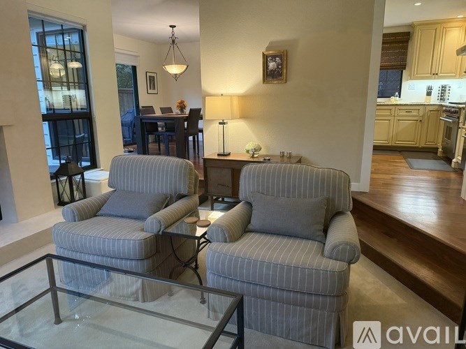 Two striped armchairs are placed in a living room.