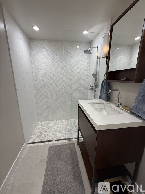 A bathroom with a white sink and a mirror.