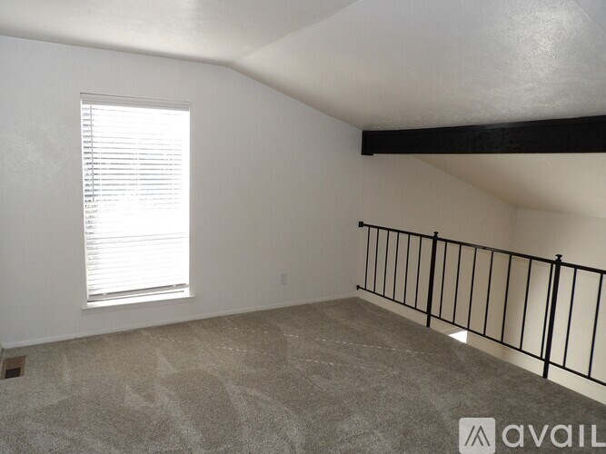 A kitchen with a sink and a refrigerator.