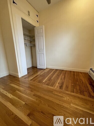 A room with wooden flooring and a white door.