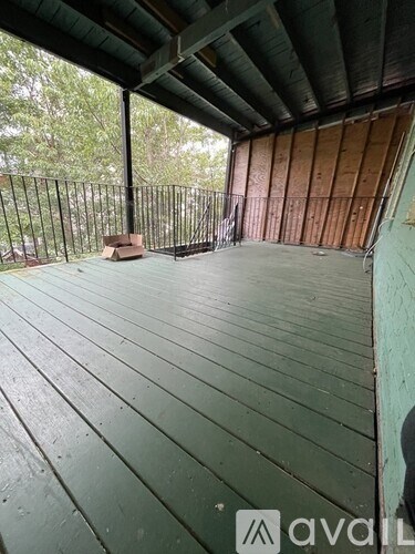 A wooden deck with a railing and a box on it.