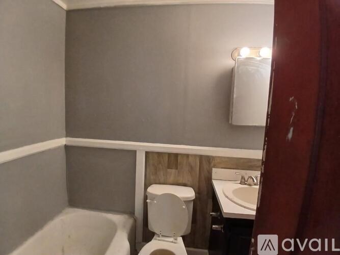A bathroom with a toilet, sink, and bathtub.