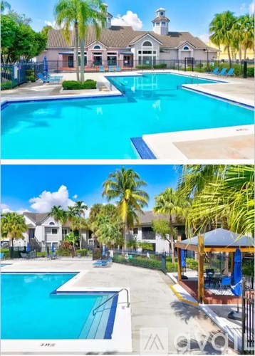 A swimming pool surrounded by palm trees and a gazebo.