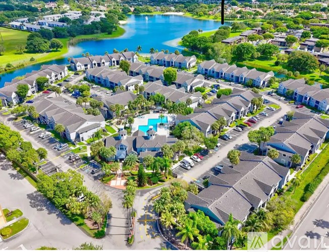 A bird's eye view of a residential area with houses and a swimming pool.