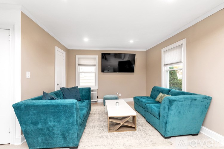 A living room with a blue couch and a white coffee table.
