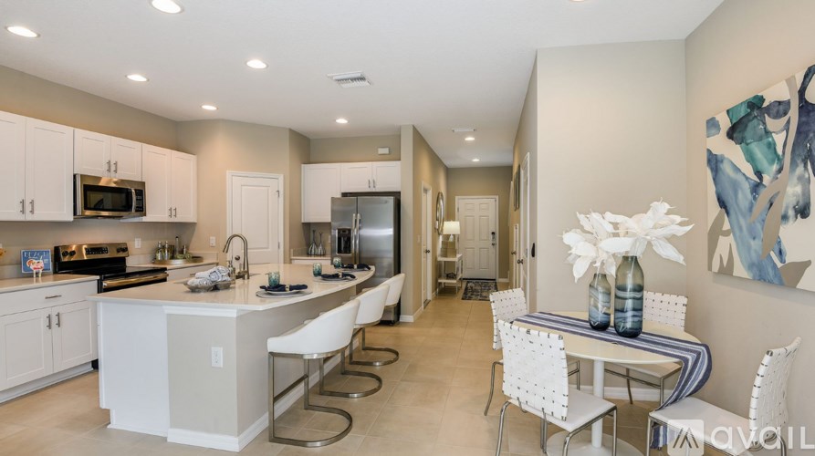 A kitchen with a table and chairs in front of a painting.