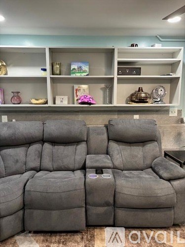 A grey sofa set with a table in front of it.