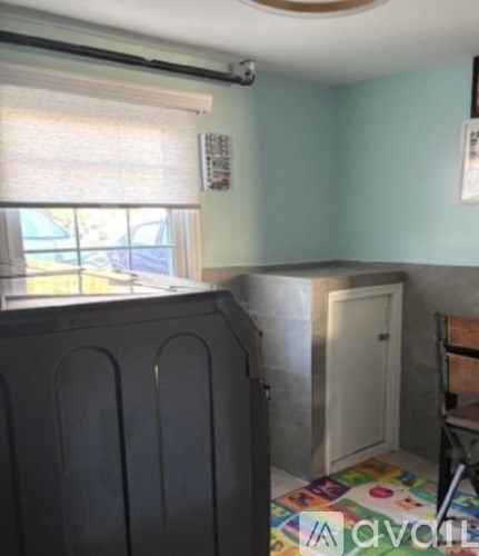 A room with a grey cupboard and a white door.