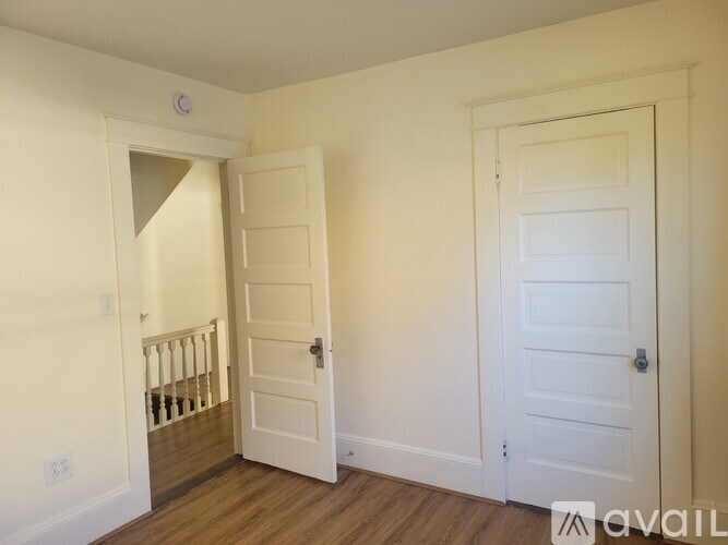 A room with two doors and a staircase.