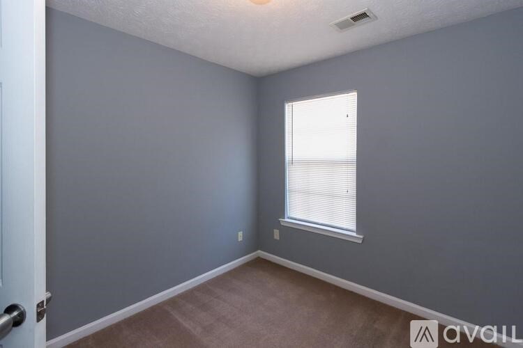 A room with a window and a door.