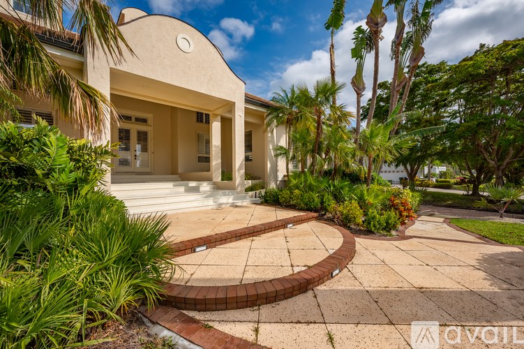 A bird's eye view of a coastal residential area with apartment buildings and a beach.