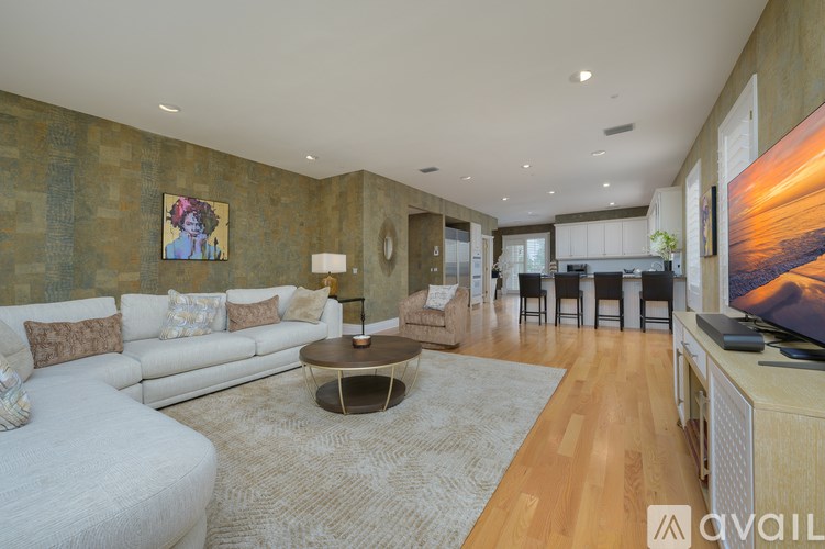 A living room with a white sofa and a wooden coffee table.